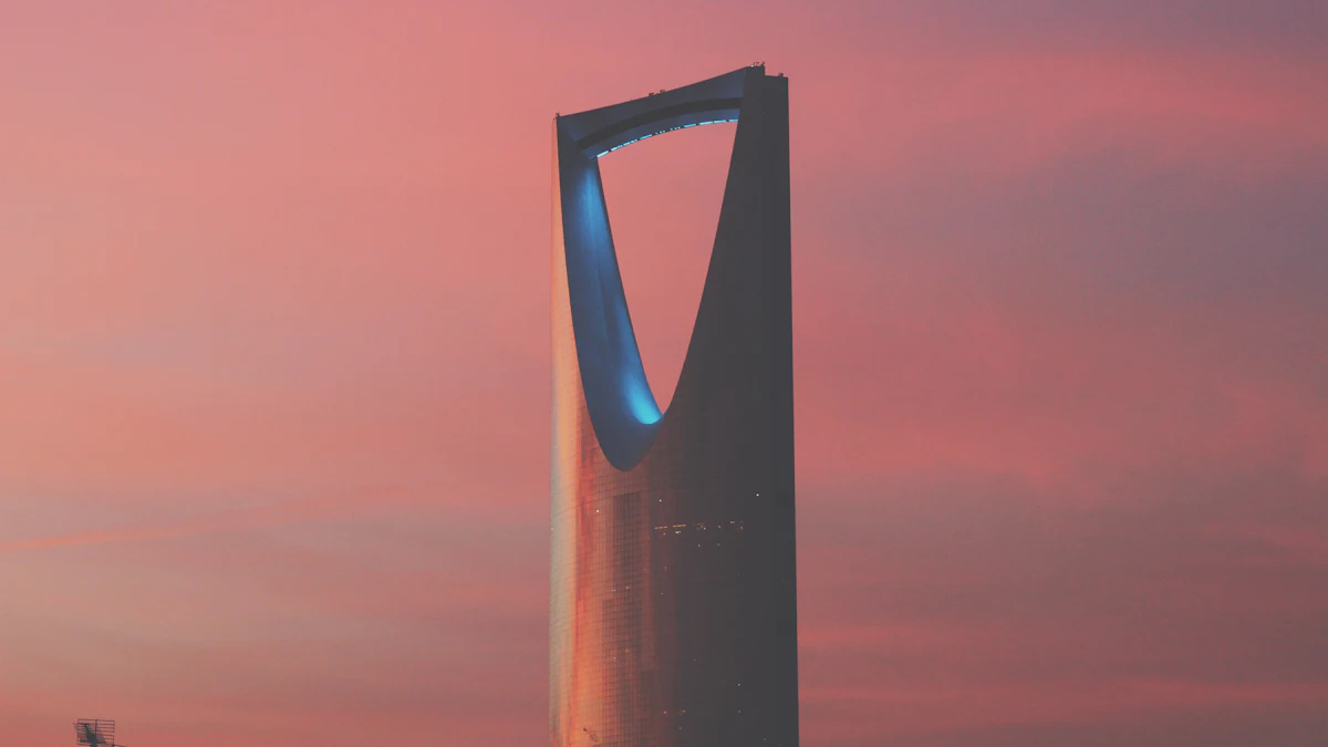 The Kingdom Centre tower in Riyadh against a pink and orange evening sky