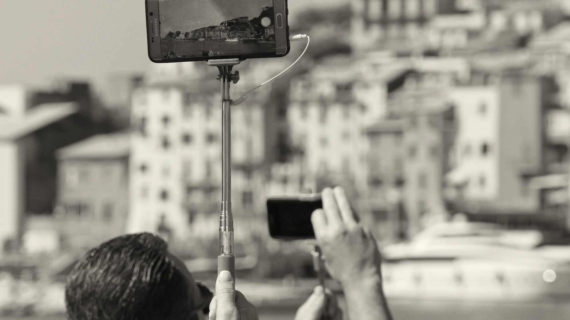 A smartphone on a tripod filming a town