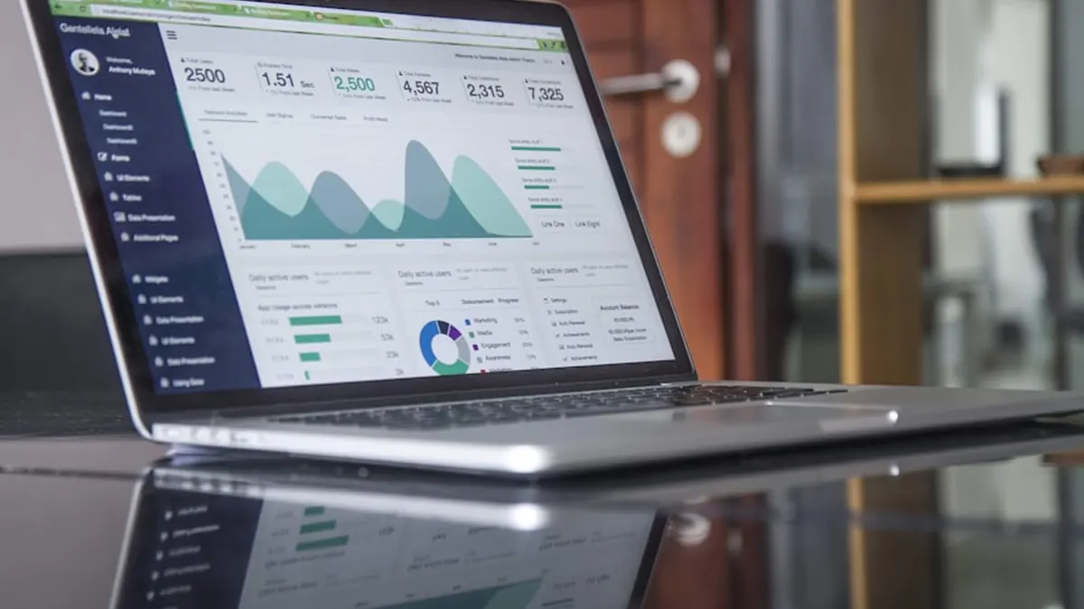 A laptop on a desk showing an analytics dashboard